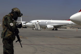 A Taliban soldier stands guard at Hamid Karzai International Airport in Kabul on September 5. Some domestic flights have resumed.