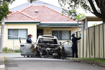 Police investigate a burnt-out car in Murdock Lane after two men were shot earlier on Osgood Street, Guildford.
