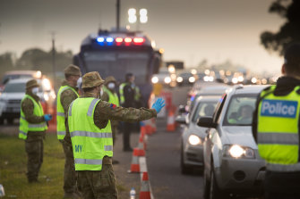 ADF personnel help police at a roadside checkpoint on the Geelong Freeway last week.