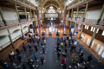 People wait to be vaccinated at Melbourne’s Royal Exhibition Building. 