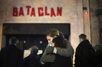 Women hug in front of the Bataclan concert hall in Paris, weeks after the attack.