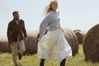 She wears: Aje “Mira” knit, $255, and “Admiration” skirt, $455; Essen “Riding” boots, $740; and Holly Ryan earrings, $420. He wears: Polo Ralph Lauren jacket, $1699,
and pants, $299; Orlebar Brown “Lorca” jumper, $575; and R.M. Williams “Rigger Commando” boots, $695.