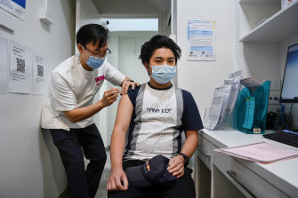 Pharmacist Quinn On administers his first Moderna vaccine to Dylan Nguyen Ton, aged 14, on Monday afternoon.
