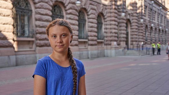 Climate activist Greta Thunberg stands next to Swedish parliament in Stockholm on Friday. The teenager often travels by train in Europe and will now sail to the US.