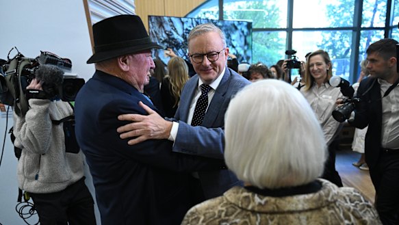 Prime Minister Anthony Albanese greets Lindsay Fox and his wife Paula before a tour of a new cancer centre in Melbourne on Friday.