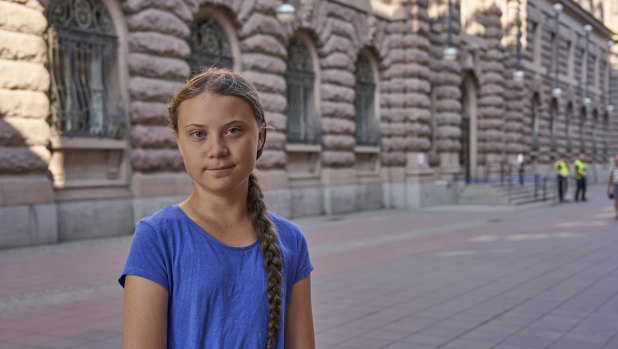 Climate activist Greta Thunberg stands next to Swedish parliament in Stockholm on Friday. The teenager often travels by train in Europe and will now sail to the US.