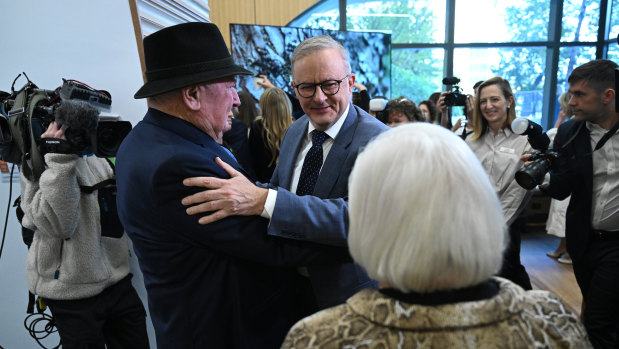 Prime Minister Anthony Albanese greets Lindsay Fox and his wife Paula before a tour of a new cancer centre in Melbourne on Friday.