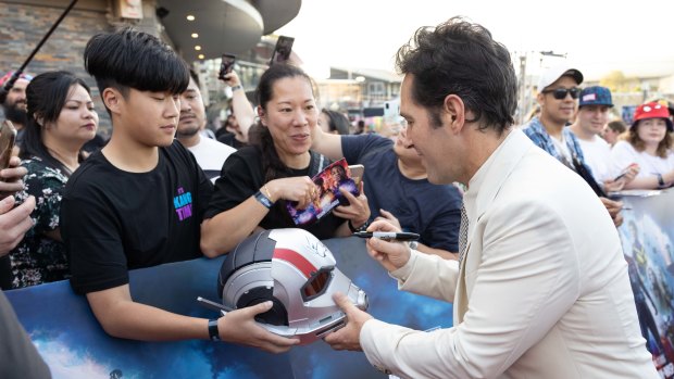 Lost count of autographs: Paul Rudd signs a fan’s Ant-Man helmet in Sydney.