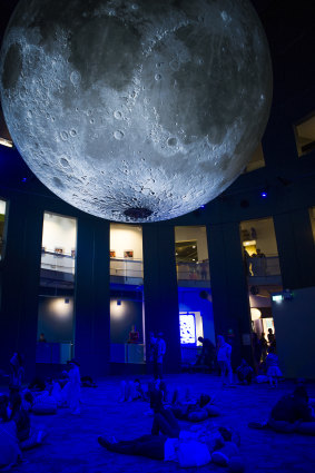Visitors took a moment to lounge beneath the new moon exhibit.