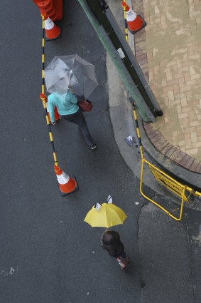 The brollies come out at a construction site in Sydney.