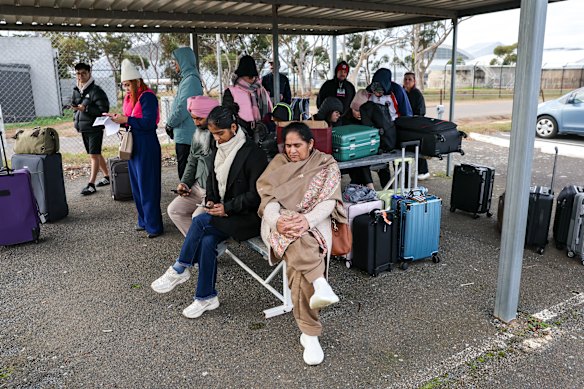 Passengers wait in the carpark after Avalon Airport went into lockdown.