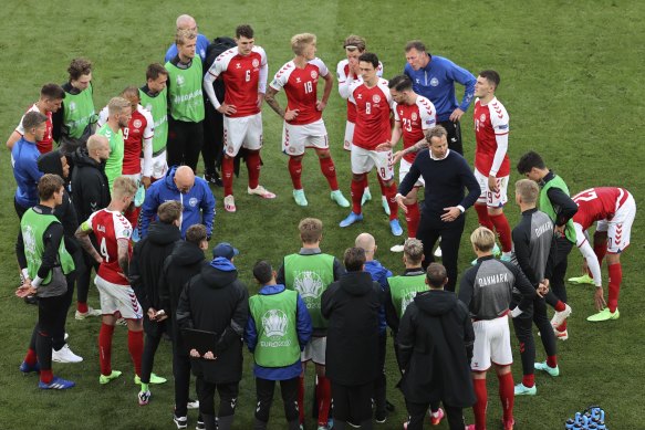 Denmark’s manager Kasper Hjulmand speaks to his players after Christian Eriksen’s cardiac arrest during the game against Finland.