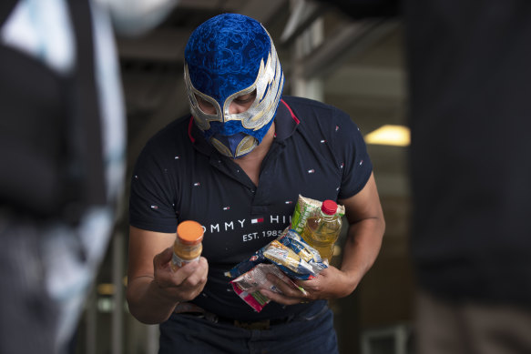 A wrestler looks at the contents of his food parcel.