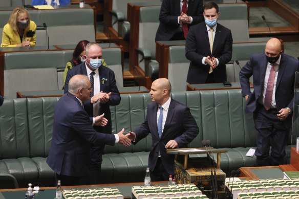 Treasurer Josh Frydenberg is congratulated by Prime Minister Scott Morrison after delivering the Budget speech.