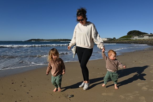 Shannon Sainty-Roach with her children Kip and Finn on the beach in Port Kembla. She is in favour of offshore wind to tackle climate change.