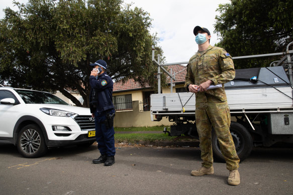 The Police and ADF conduct checks in Lakemba to see if people are home who are meant to be in isolation. 
