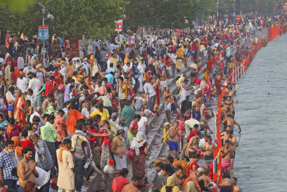 Devotees take holy dips in the river Ganges during the religious observance of Kumbh Mela, in Haridwar.