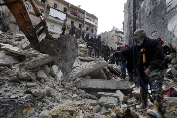 Syrian Civil Defence workers and security forces search through the wreckage of collapsed buildings after a devastating earthquake rocked Syria and Turkey, in Aleppo, Syria.