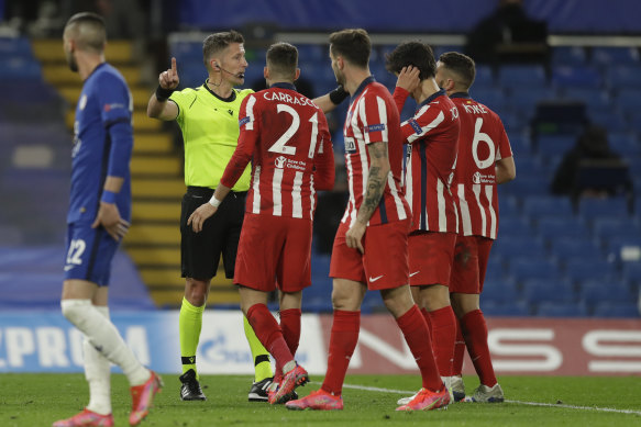Atletico players unsuccessfully argue the toss after referee Daniele Orsato declined to award the Spaniards a penalty against Chelsea.