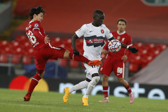 Awer Mabil, right, jostles for possession with Liverpool's Takumi Minamino.