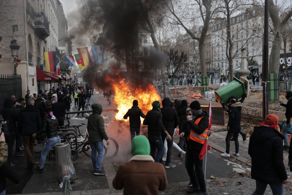 Demonstrators stand next to a burning barricade during a protest against the recent shooting at the Kurdish culture center in Paris on Saturday.