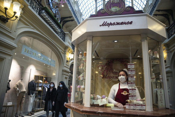 An ice-cream seller waits for customers at a department store as Russia began reopening on Monday.