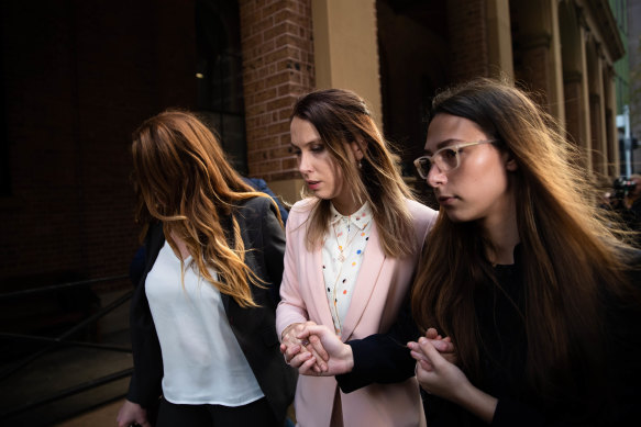 Hannah Quinn, with her supporters, leaves the Supreme Court. 