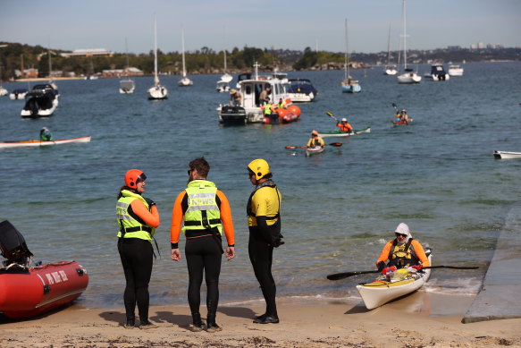 Rescue workers responsible for freeing a trapped whale arrive at Little Manly.