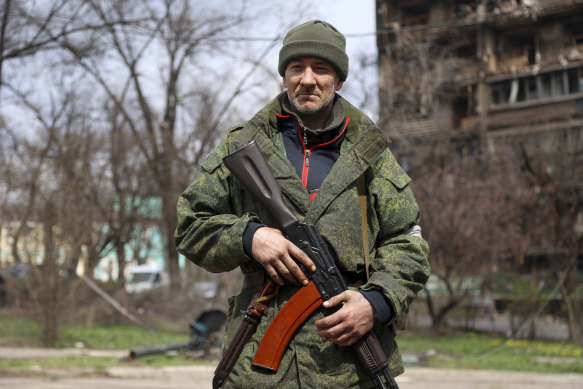 An armed serviceman of Donetsk People’s Republic militia patrols a street in an area controlled by Russian-backed separatist forces in Mariupol, Ukraine, on Friday.