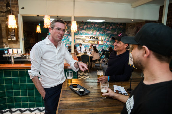 NSW Treasurer Dominic Perrottet has a beer at The Balmain Hotel on Friday as pubs are allowed to open to 10 diners. 