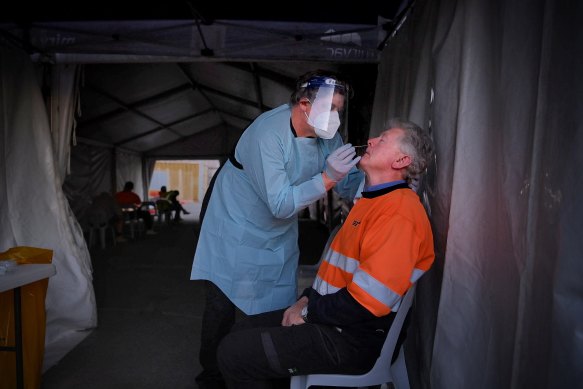 A worker is tested at a Mirvac construction site at Green Square.