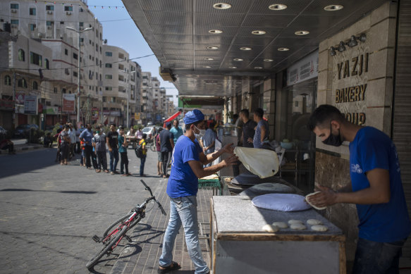 Palestinians line up to buy bread during a 48-hour lockdown.