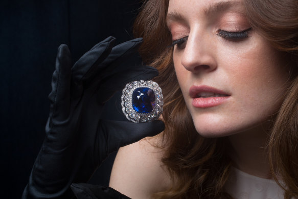 Caitlyn McMahon models the 118.88-carat sapphire that is on display in an exhibition by royal jeweller Garrard in Melbourne this week.