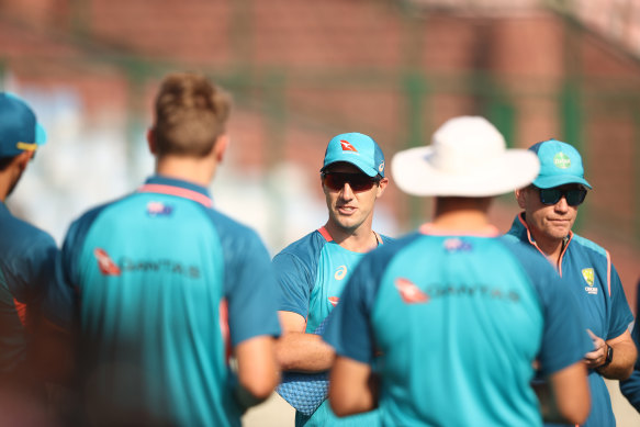 Pat Cummins talks with teammates during an Australian Test squad training session at Arun Jaitley Stadium on Wednesday.