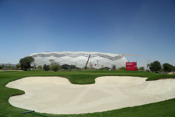 The stadium, pictured in the background, is one of several being built in Qatar ahead of the 2022 World Cup. 
