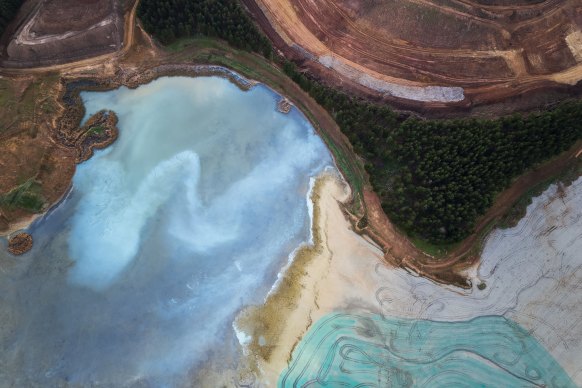 Sun rises over the Cadia mine, highlighting the colours in its tailings dam.