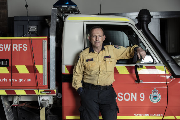 Former prime minister Tony Abbott pictured on Sunday in his role as a volunteer firefighter. 