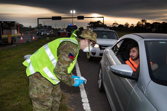 The defence forces checking drivers on the Geelong highway on June 10.