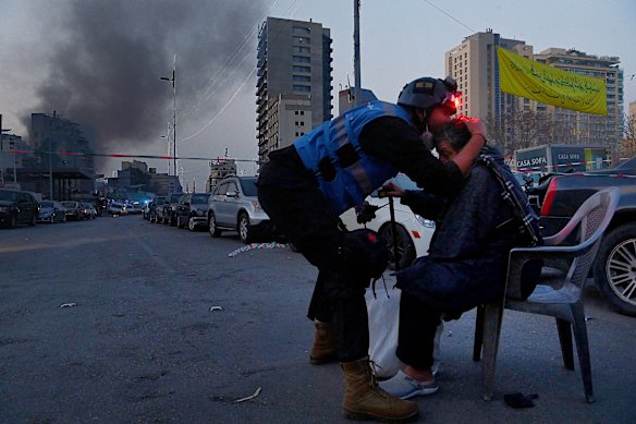 Kate Geraghty’s powerful photograph of a Lebanese emergency first responder kissing the head of an elderly man moments after a building in the Bachoura district in central Beirut was hit by one of three Israeli airstrikes on March 12.