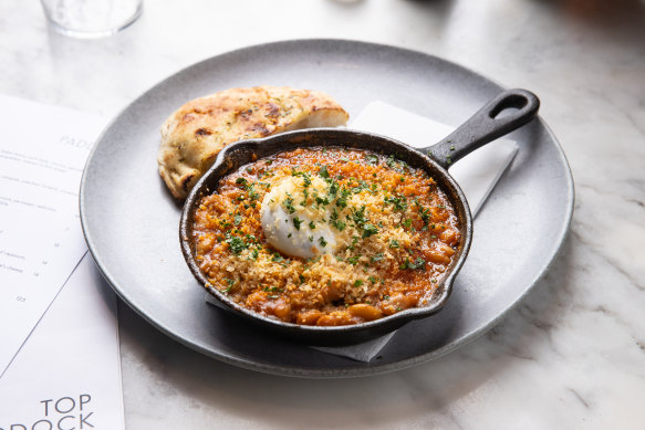 Top Paddock’s ‘breakfast cassoulet’ a jumble of baked beans, pork belly, chorizo and pancetta topped with a runny egg.