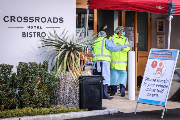 Medical staff at a pop-up COVID-19 testing clinic in Casula in NSW, where the local Crossroads Hotel is now a hotspot.