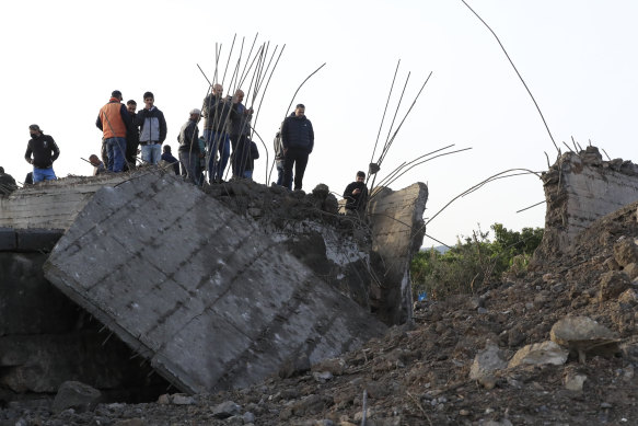 People check a small bridge that was destroyed by an Israeli airstrike, in Maaliya village, south Lebanon on Friday.