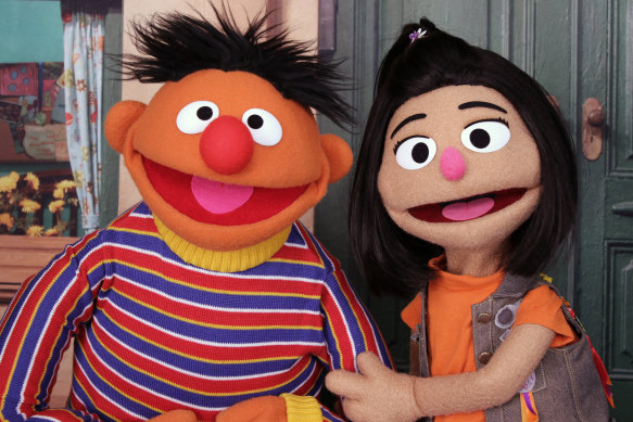 Ji-Young (right), pictured with longtime Sesame Street character Ernie, is the first Asian-American Muppet on the long-running children’s program. 