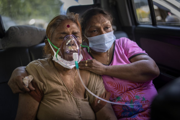 A COVID-19 patient receives oxygen inside a car provided by a Gurdwara, a Sikh house of worship, in New Delhi, India, while waiting for a hospital bed. 