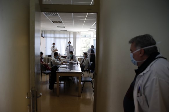 The medical students attend a morning meeting with the doctors at Sotiria Hospital's pathological clinic.