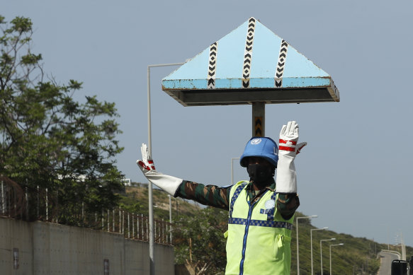 A UN peacekeeping soldier directs traffic at a road that links to a UNIFIL base in Naqoura town, Lebanon.