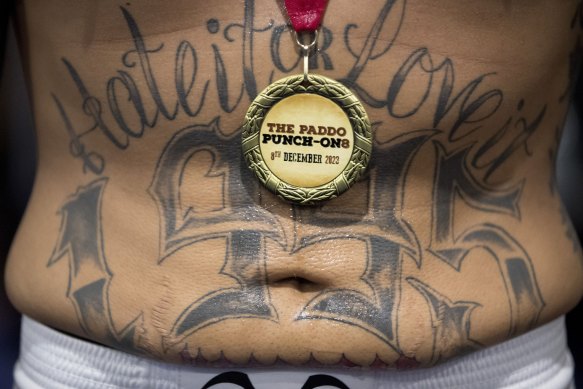 A boxer wears a winners’ medal after his fight at ‘The Paddo Punch On’. 