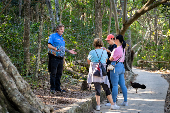 First Nations guide Jason Passfield walking with the group through the rainforest.