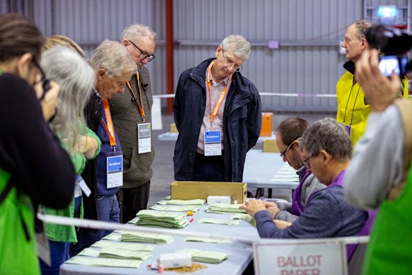 Scrutineers oversee the recount of votes in Bradfield.