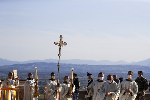 A procession walks through the streets of Assisi, Italy, before the beatification ceremony of Carlo Acutis.